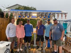 6 fishers holding their bountiful catch at Shalimar