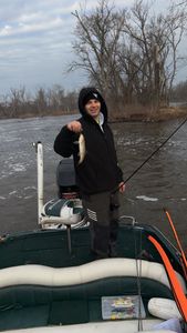 Angler holding fresh caught fish on boat in Fort Atkinson WI waters