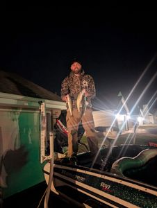 Night fishing scene showing caught walleye from Fort Atkinson WI with boat and bright lights