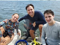 Three people enjoying a fun fishing cruise in FL