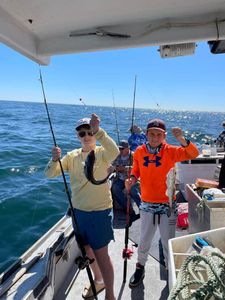 Two teenage anglers celebrating their catch.