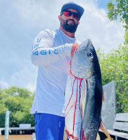 Angler holding a 22-inch fish in San Juan