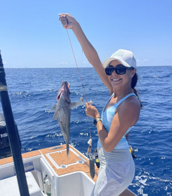 One fishing person holding a 15-inch fish in PR