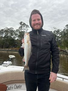 A fisherman holds a spotted weakfish in GA