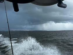 Deep sea jigging and trolling with light tackle under partly cloudy skies.