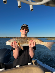Reeling in a big one on the peaceful waters.