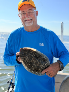 Nice Southern flounder using deep sea jigging and light tackle in partly cloudy conditions.