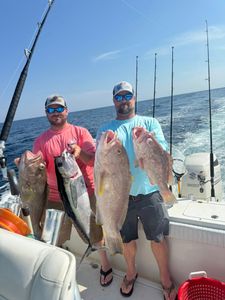 Two anglers with caught gag grouper and blackfin tuna at Panama City Beach