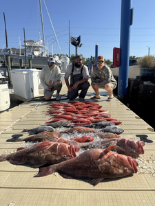 Three people fishing with two large fish at Panama City Beach
