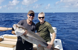 An angler with a large fish in a scenic FL setting