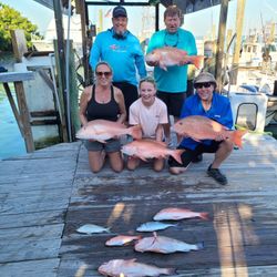 Fishing group displays mutton snapper and red snapper catch on dock in Islamorada FL