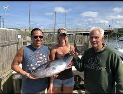 Anglers catching large fish in Neptune City
