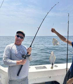 A person fishing in the waters of Neptune City