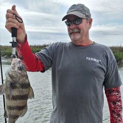 A fisherman holding a black drum fish on Hilton Head Island