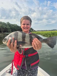 A person fishing for a large black drum fish on Hilton Head Island