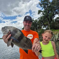 Angler holding a black drum fish caught at Hilton Head Island