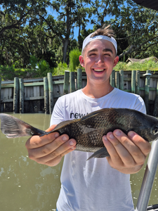 Huge Black Drum hooked while jigging through stormy skies!