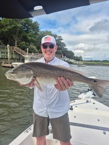 Angler catching a 31-inch redfish in SC