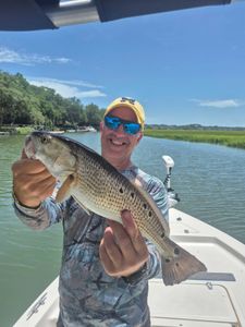 Angler holding a big redfish in SC
