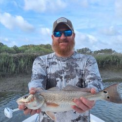 Angler holding a large redfish, fishing on Hilton Head Island