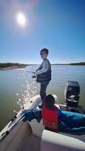 Angler casting fishing rod while standing on shore in SC