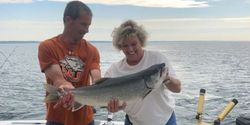 Two people fishing for a big fish in NY