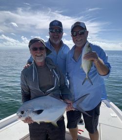 Two permit fish being caught while fishing in Florida