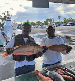 2 fishermen holding their catch in FL