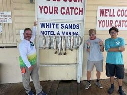 Three people enjoying a fishing trip at South Padre Island