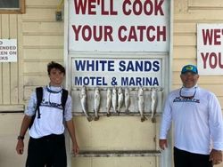 Two people fishing on the beach at South Padre Island