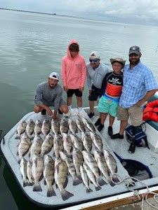 5 people fishing for 2 big fish at South Padre Island