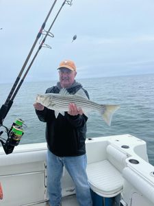 Cape Cod angler with a prized striped bass.
