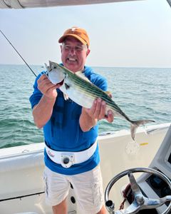 A fisherman holding a 20-inch Atlantic Bonito in MA