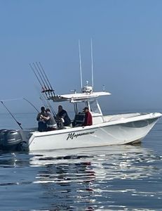 Three people enjoying a fishing tour in East Dennis