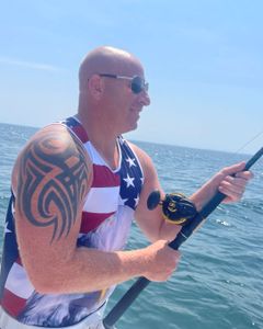 Angler fishing in MA waters