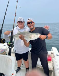 Striped bass caught by two people during fishing tour in East Dennis