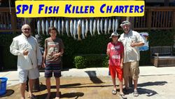 Four people enjoying a fishing trip at South Padre Island