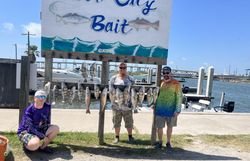 Two anglers reeling in a great catch at Aransas Pass