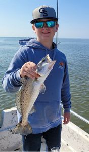 Our young angler hooks prized Spotted Seatrout!