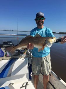 A photograph of a 29-inch redfish caught while fishing in Brunswick.