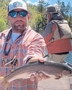 Solid rainbow trout on a fly fishing float