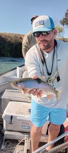 Angler catching a rainbow trout in California