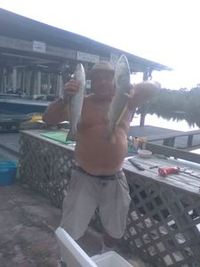 Two fishermen with a successful catch in Florida