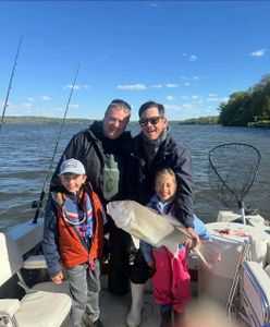 Fishing trip on lake in Accord NY with caught fish displayed on boat