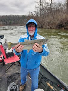 Angler with a beautiful rainbow trout caught in Cadillac