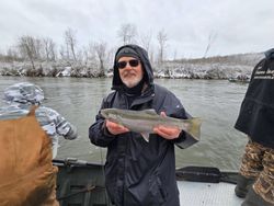 Angler holding a rainbow trout in Cadillac