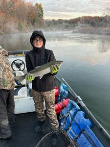 Angler with a large rainbow trout in Cadillac, fishing