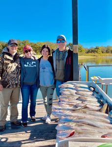 Four people enjoying fishing and hunting in the scenic location of Kingston