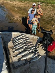 Four people enjoying a fishing and hunting adventure in OK