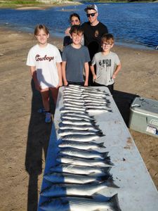 Anglers with striped bass catch in Oklahoma